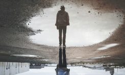man's reflection on body of water photography