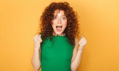 a woman in a green dress making a funny face